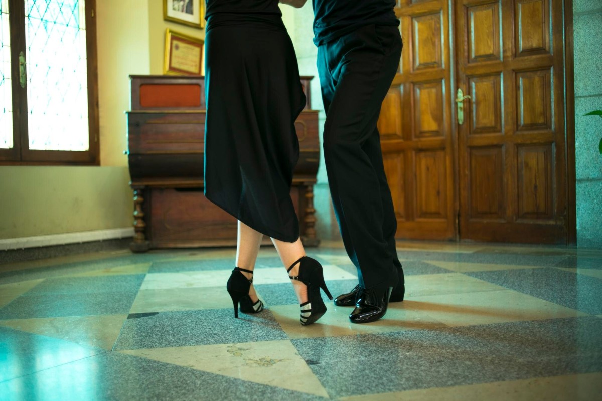 Couple practicing tango steps at home